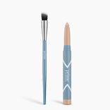 A blue-handled brush with a silver ferrule stands beside a blue crayon-style matte stick with a beige tip, both labeled "PrimePrometics™," from the Seamless Shadow Bundle Matte, on a white background.