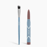 A blue Cream Eyeshadow Brush with a silver ferrule and two-toned bristles sits beside the PrimePrometics™ Seamless Shadow Bundle Matte—a blue makeup stick labeled "prime" with a brown tip—ideal for flawless matte eyeshadow application.