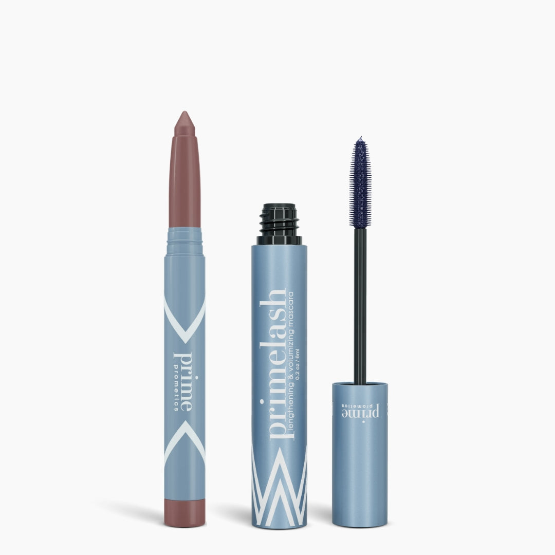 Two blue cosmetic containers: a lipstick crayon with the cap off, showing mauve, and an open tube of PrimePrometics™ Iconic Matte Eye Kit mascara with a black brush. Both display PrimePrometics™ branding on their packaging.