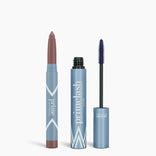 Two blue cosmetic containers: a lipstick crayon with the cap off, showing mauve, and an open tube of PrimePrometics™ Iconic Matte Eye Kit mascara with a black brush. Both display PrimePrometics™ branding on their packaging.
