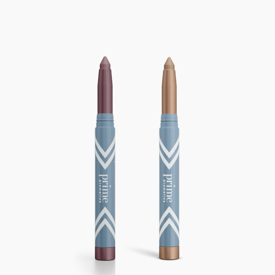 Two blue PrimePrometics™ PrimeEyes Eye Brightener sticks with white chevrons stand upright, one with a mauve tip, the other gold—ideal as an eye brightener or under eye cream for a refreshed look. Set includes 2pcs.