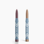Two blue PrimePrometics™ PrimeEyes Eye Brightener sticks with white chevrons stand upright, one with a mauve tip, the other gold—ideal as an eye brightener or under eye cream for a refreshed look. Set includes 2pcs.